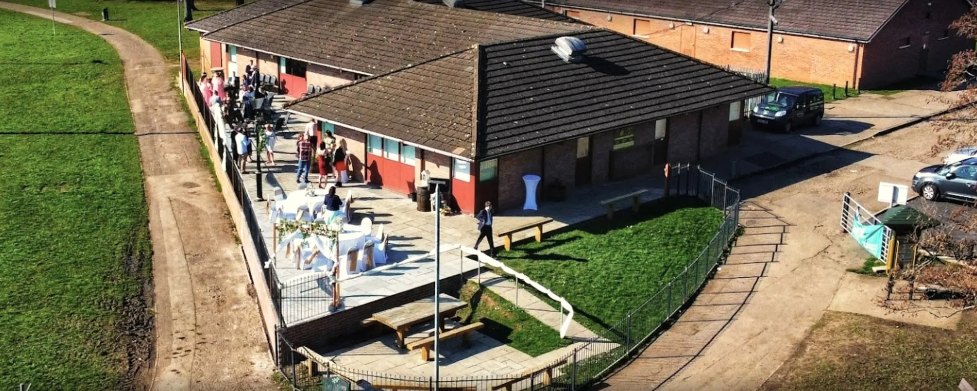 Aerial view of The Olive Tree and its patio beside the fields