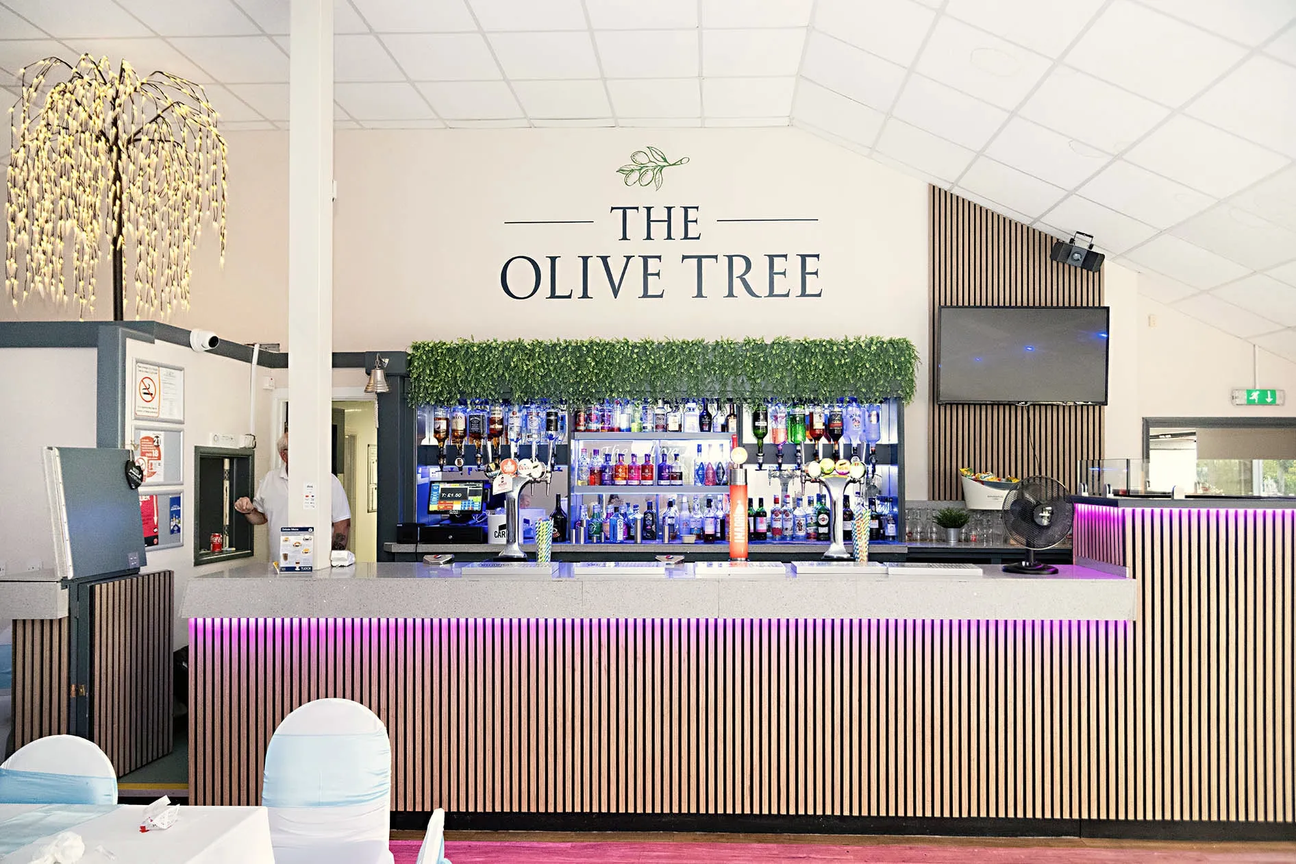 The bar, with its slatted wood front and foliage canopy