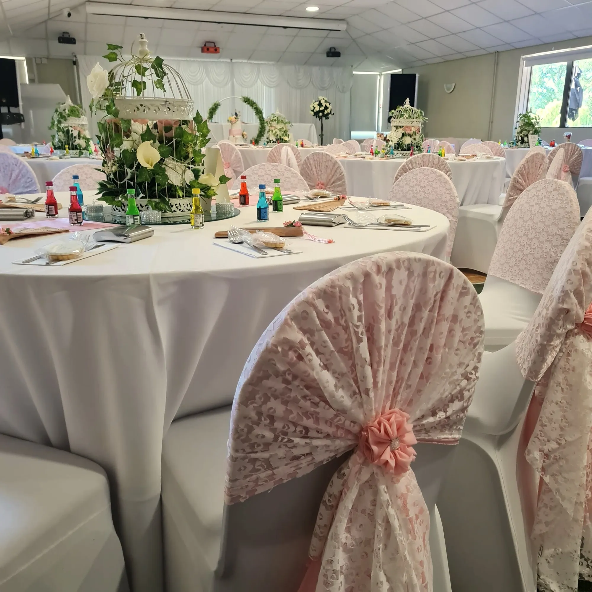 Round tables with blush lace chair sashes