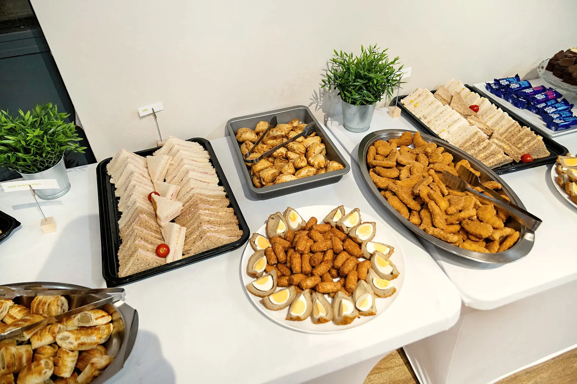 Platters of sandwiches, sausage rolls and savoury bites