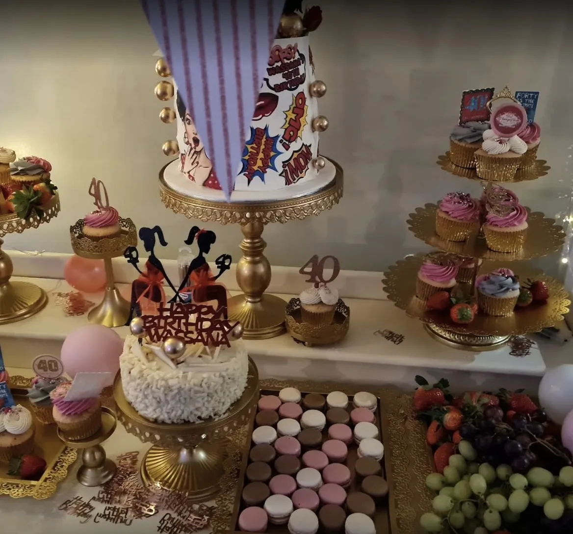 Dessert table with a celebration cake, macarons and fruit