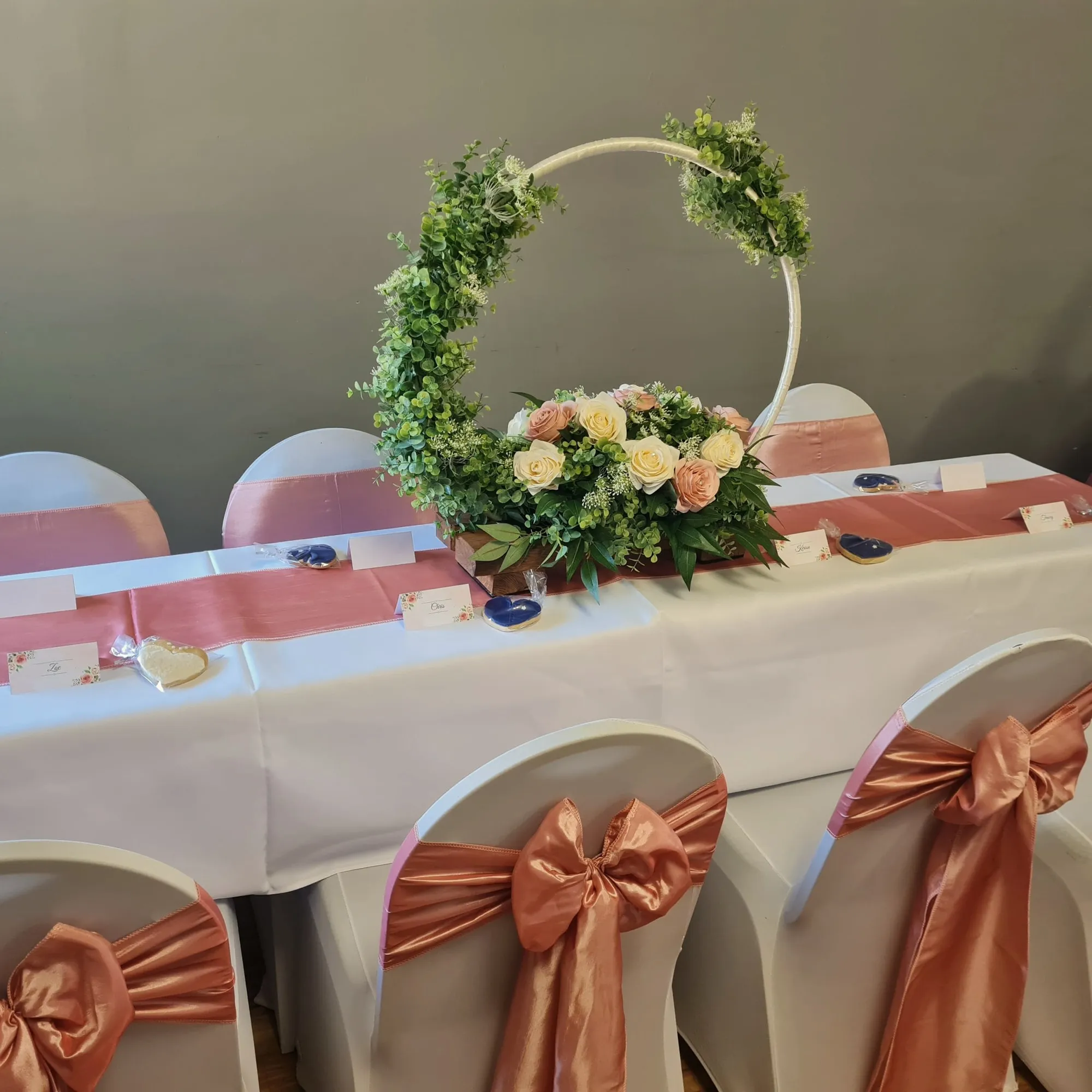 Floral hoop centrepiece on a coral-themed table