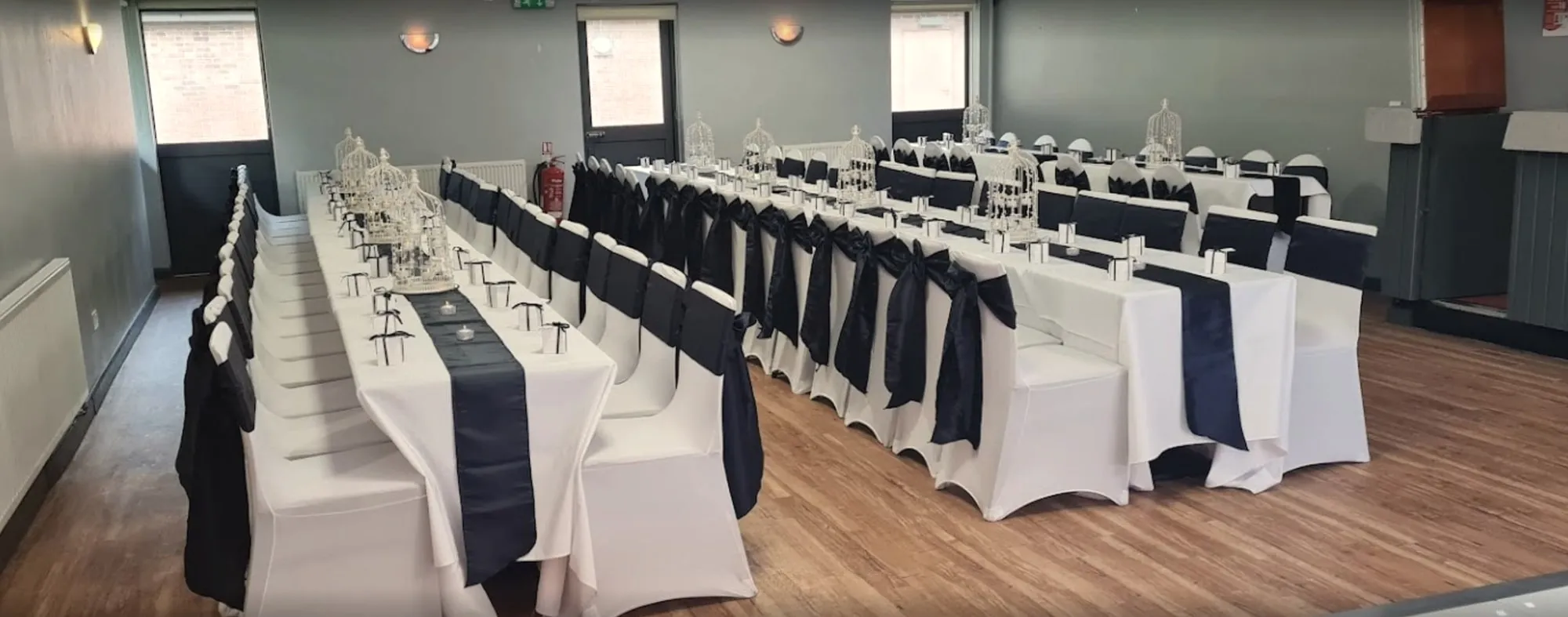 Long tables dressed in white and navy