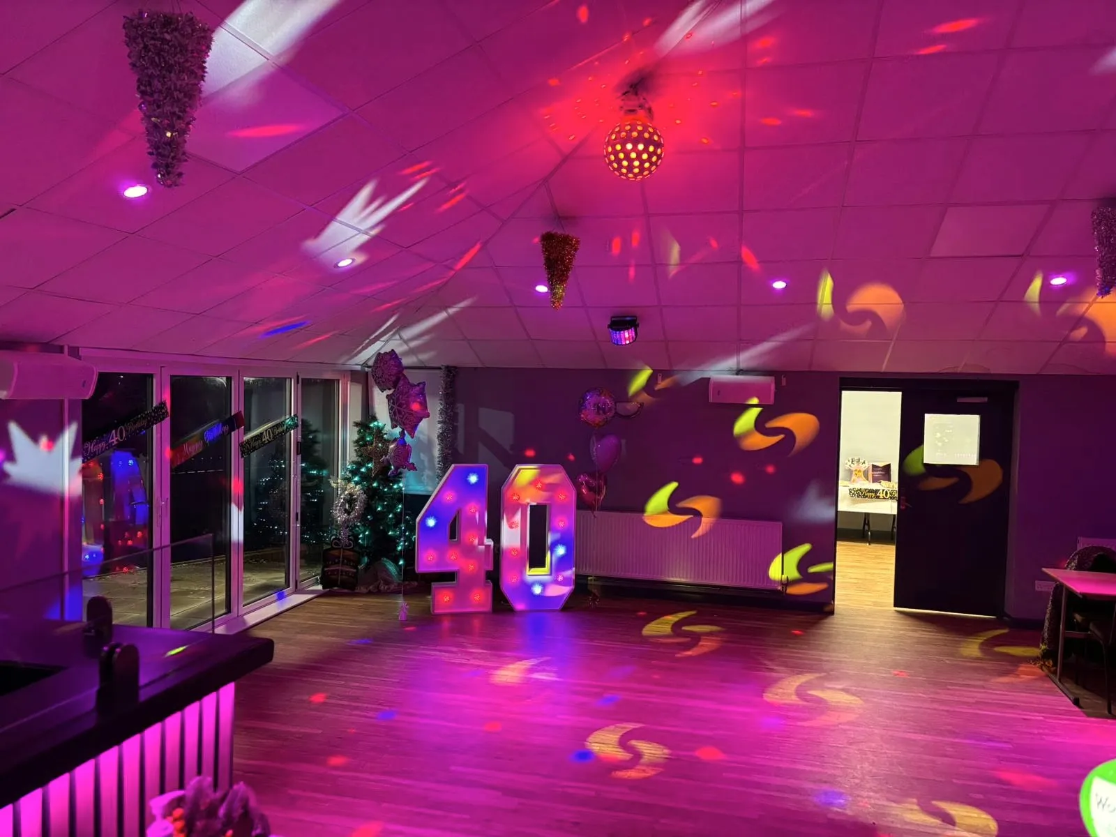 Dance floor washed in pink light for a 40th birthday party