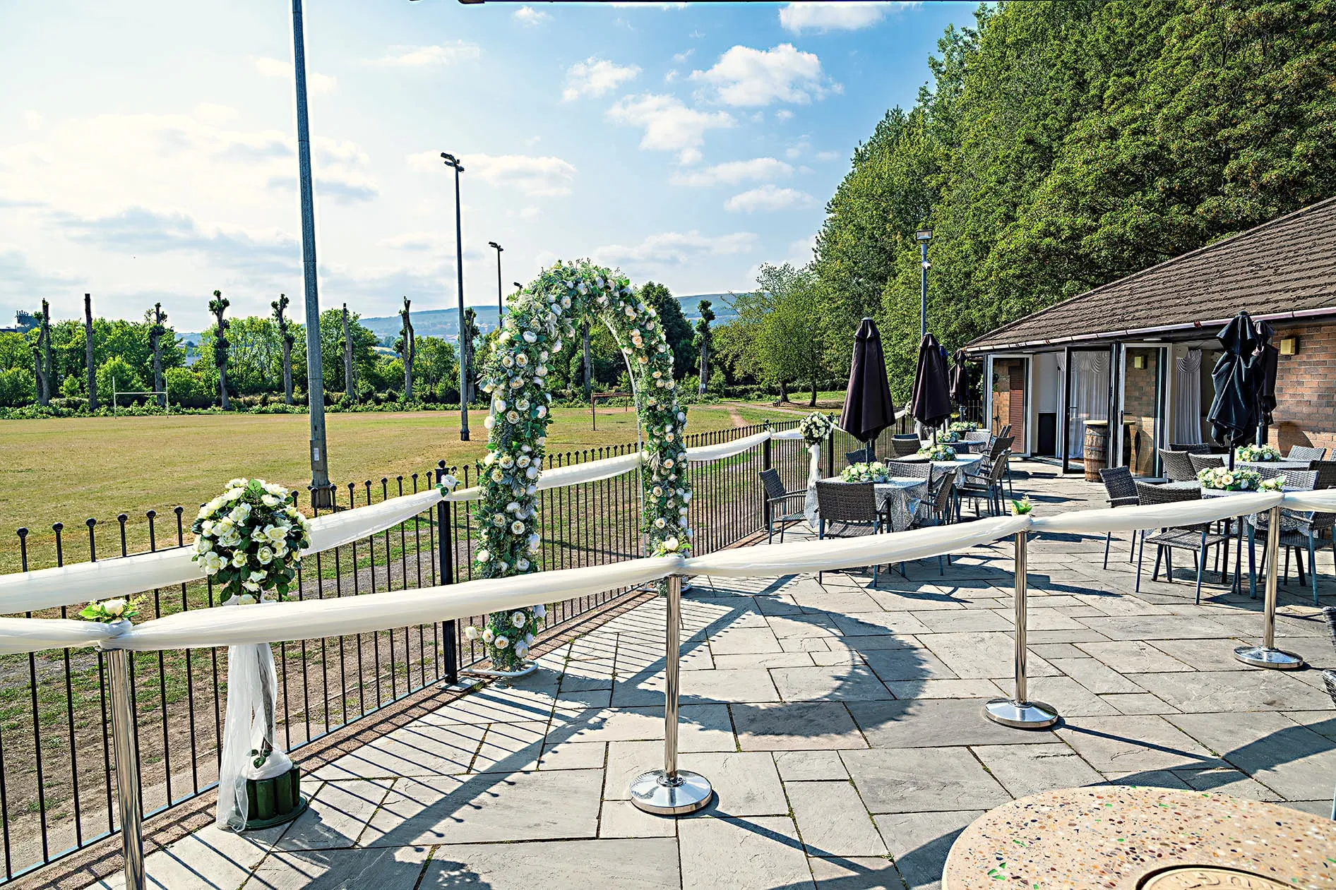 The patio dressed for a wedding, looking out across the fields