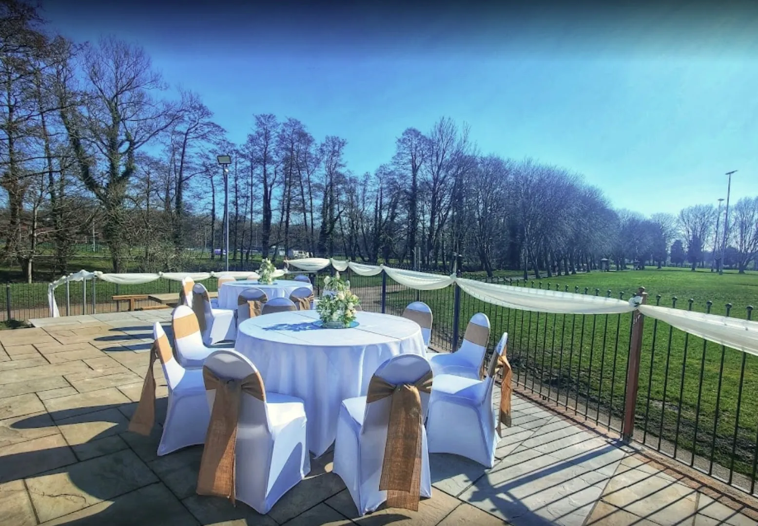 A dressed round table on the patio overlooking North Fields