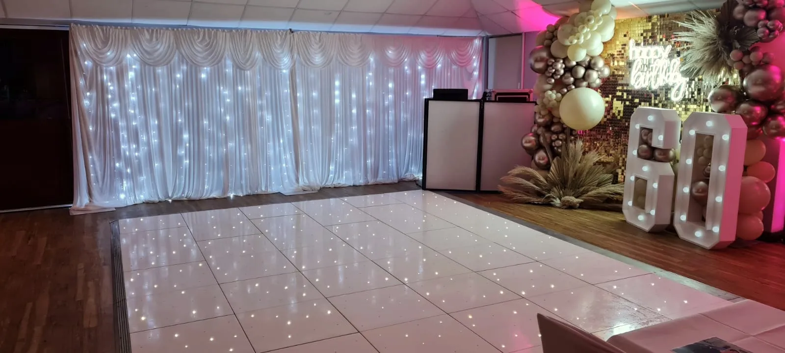 Starlit backdrop and LED dancefloor set for a 60th birthday