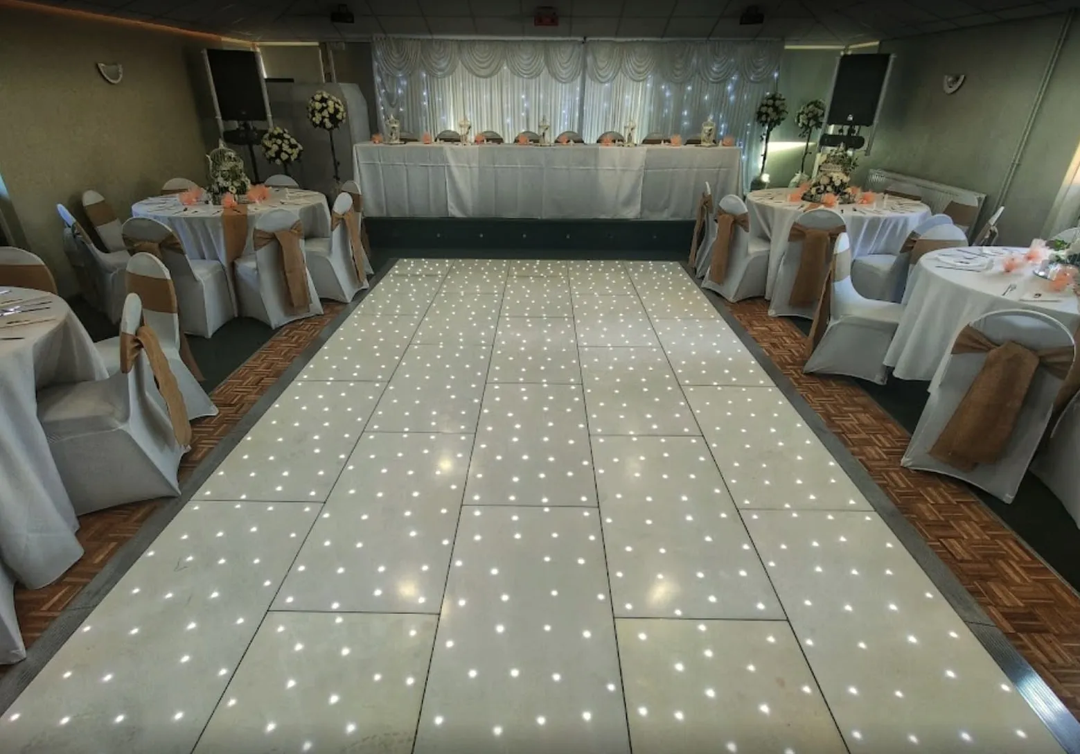 Starlit dancefloor leading to a top table with a twinkling backdrop