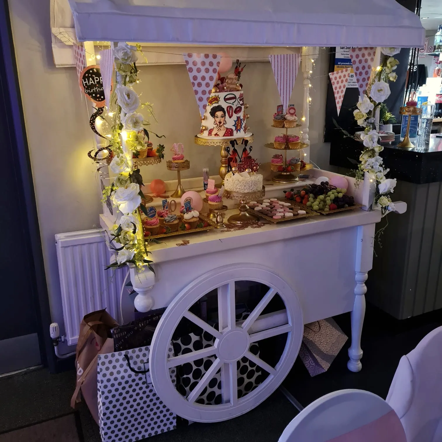 Sweet cart strung with fairy lights and filled with treats