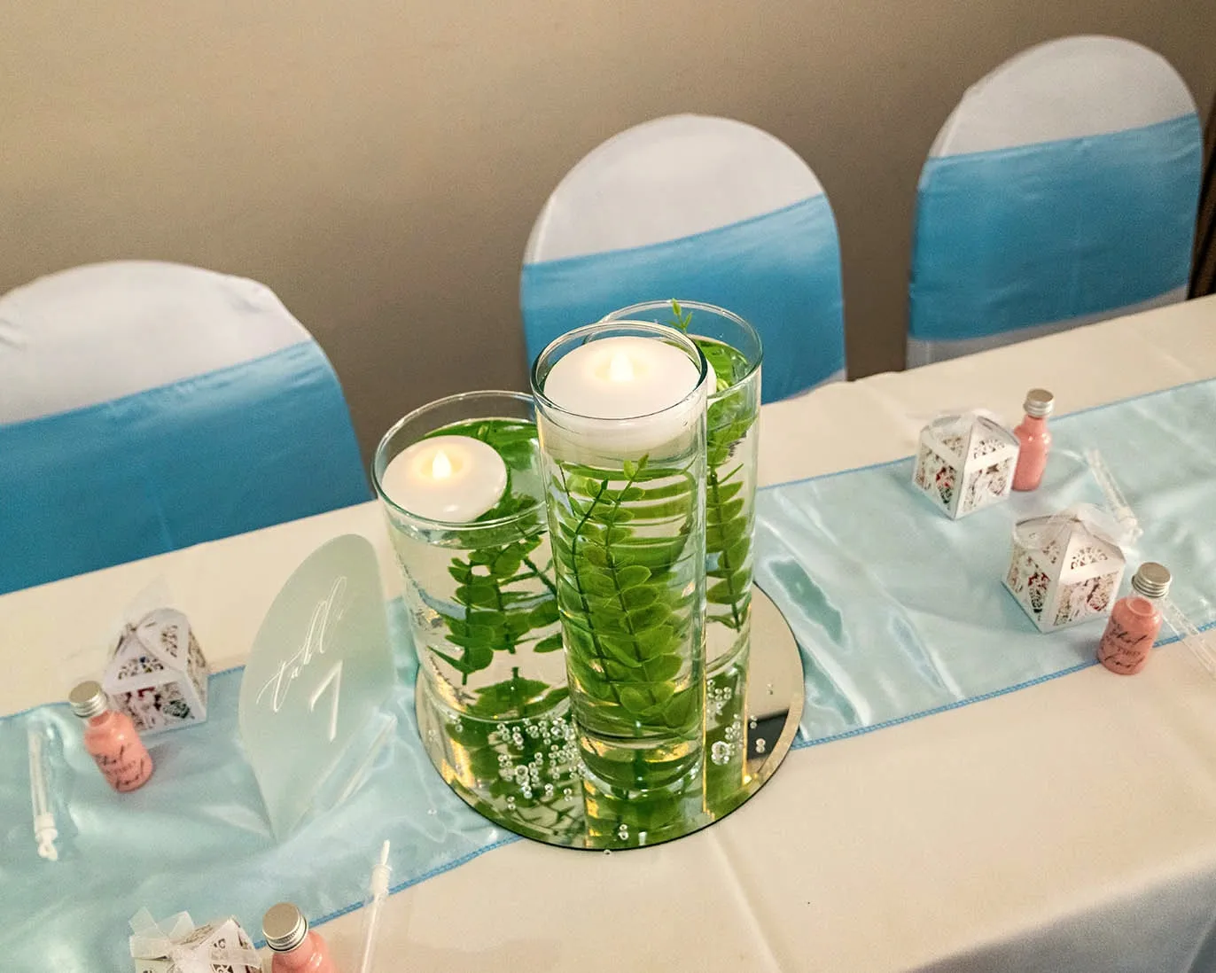 Table centrepiece of floating candles and greenery